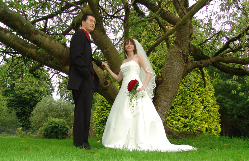 Jon and Shanelle beside tree.