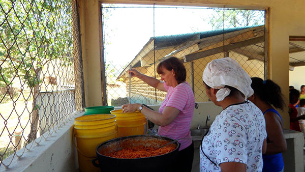 Serving juice and spaghetti for the children